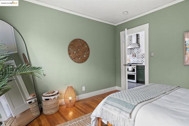 Bedroom with crown molding and hardwood / wood-style floors