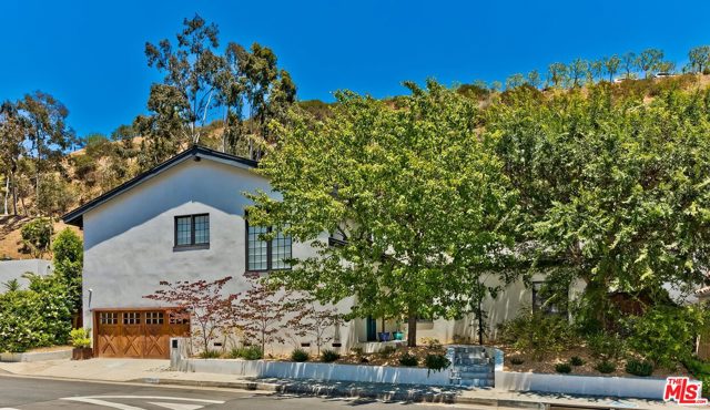 1944 N Beverly Drive Beverly Hills, California Immaculately renovated 5 bedroom home sits on a quiet, no-outlet section of N Beverly Drive. The light-filled open floor plan flows from the chef's kitchen with top-of-the-line appliances to the dining area and living room with beamed ceiling and fireplace. Multiple French doors open to a private backyard with patio, pool, sauna, and rooftop sundeck. The entire upstairs level serves as an expansive master suite with vaulted ceilings and its own fireplace, private deck, double entry shower, and two walk-in closets. Downstairs find three bedrooms, one en suite and a jack and jill. The fifth bedroom could act as a home office or guest suite with en suite bath and separate entrance. Other features include beautiful hardwood floors throughout, rooftop solar panels, a smart home and speaker system. Walk to Coldwater Canyon Park and Franklin Canyon hiking trails and minutes from shops and restaurants of Beverly Hills.