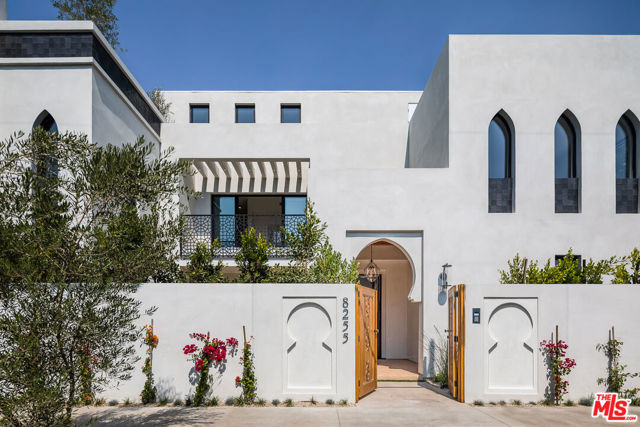 8255 Oakwood Avenue Los Angeles, California Villa Casbah, positioned on an oversized corner lot in trendy Beverly Grove, is a brand new contemporary Moroccan estate spanning 5514 SF, making it one of the largest homes in the area. Ensuring seclusion, the home sits behind a facade of custom designed ironworks and hand-carved wooden entry gates. Intricately designed, the home boasts 6 spacious beds & 7 resort-style baths featuring authentic Moroccan touches such as Tadelakt plaster walls, hand-made lighting, imported hardware, & zellige tiles. The luxe finishes continue w/ the finest natural stones, top grade appliances, and custom cabinetry throughout. Imported Moroccan arched windows allow for an abundance of natural light while Fleetwood doors provide an open flow to the pool, spa, & stylish covered patio. At the pinnacle of the home, an entertainment room sits adjacent to a rooftop deck highlighted by a vantage point across LA and outfitted w/ a kitchen & dumbwaiter for dining alfresco. For added privacy, a security system is integrated throughout, while the latest in smart home tech controls the lighting, temperature, music, & more. With an abundance of additional resort amenities, like a walk-in 100+ bottle wine cellar, this home has been elevated to the highest luxury standard & primed for everyday enjoyment.