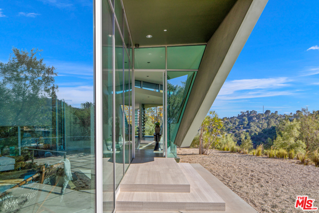 8520 SKYLINE Drive Los Angeles, California Private Architectural Retreat on over 1.5 acres built by globally significant architect Hagy Belzberg. The Skyline Residence represents one of a kind; award winning architecture. Winner of numerous published awards this gated, contemporary/modern compound has an open floor plan, that includes 5 bedrooms in the main house with views from every room. The detached 2 story guest house has 1 bedroom, its own kitchen. The compound has rare 280 views of both city and valley, and an infinity pool with direct city views. The front garden has a movie projector screen.