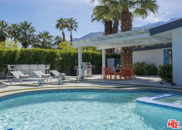 1400 N Fiesta Road Palm Springs, California Swanky 1973 Modern in Exclusive El Mirador! Designed and furnished by Christopher Kennedy, this home is can be offered turn-key per inventory outside of escrow. Recently re-plastered pool, beautifully re-tiled and expanded spa, updated HVAC and AV systems, Nest Security Cameras, indoor speakers, subwoofers and surround sound. Bosch appliances that make a seamless kitchen experience for a home cooked meal in this gorgeous chef's kitchen. There are sleek ceaserstone counter-tops as well as custom cabinetry. Custom lighting, window treatments, outdoor lighting throughout. Property has a purchased 9.8 KW DC Solar array. Jaw dropping views from your energy efficient dual glazed windows and doors. Circle driveway with a 2 car garage, that is presently being used as a Rec Room that has a HVAC split system. Amazing fabrics, texture and furnishings make this a beautiful home in the paradise that is Palm Springs. Centrally located near shops and restaurants in the design district. Very good short term rental history. Between location, amenities, and style this modern abode has everything to be your own oasis. Just bring your suitcase and enjoy!