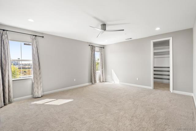 Primary bedroom with large walk-in closet with custom organizers.