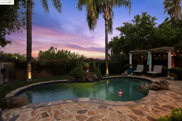 View of pool with a patio, a pergola, and a fenced backyard