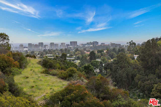 1436 BENEDICT CANYON Drive Beverly Hills, California Fantastic Development opportunity with views, gated, and a large flat pad just minutes from the Beverly Hills Hotel. Unprecedented almost 2-acre lot with existing guest house and allowable square footage for an additional 10,000 sqft house. Build a multimillion-dollar house with views up a long driveway with a guest house and gatehouse minutes from Rodeo dining and shops. Bring all developers!