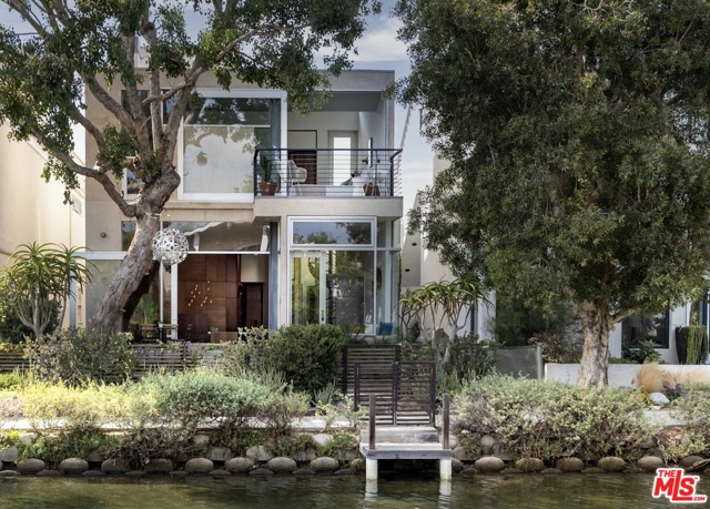 419 Howland Canal Venice, California This published architectural home, designed by Glen Irani situated in coveted Canals of Venice is a peaceful retreat filled w/ luxury comforts & creative, modern design. 3 level residence, 3 bed/ 3 bath offers a spacious, open floor plan, walls of sliding glass doors, custom walnut cabinetry & brass hardware & rooftop garden. An abundance of light, beautiful views of the canal & sea breezes fills this home! A spectacular open chefs kitchen w/ state-of-the-art appliances & expansive double height living space w/ curvilinear walls & an architectural fp. 1st floor opens to a garden & patio w/ fire pit & bbq perfect for entertaining. Guest suite, cozy den, & 2 car garage w/ ample storage complete the ground floor. 2nd floor, there is a grand screening room or office, guest suite, & primary suite feat walk-in closet, large bath, & outdoor balcony. 3rd floor rooftop deck, stocked w/ hot tub, outdoor shower, & steel & glass solarium room. This gem of a home, filled w/ built-in architectural features, luxury comforts, & plush outdoor spaces, creates a relaxing oasis secluded from the world outside. A rare home, perfect for entertaining friends to retreating into ones own private compound. Situated close to the beach and nearby Venice shopping & eateries, this is Venice living at its best!
