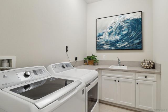 Doing laundry in this spacious laundry room won't seem like a chore. Stay organized with plenty of cabinet space.