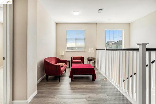 Living area featuring light wood-style floors and baseboards