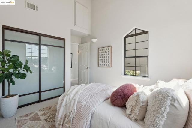 Carpeted bedroom featuring a high ceiling