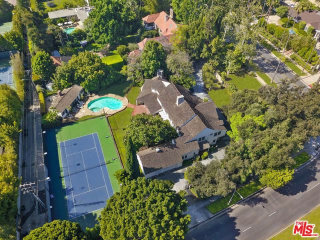 814 Foothill Road Beverly Hills, California Welcome to The Beverly Hills Tennis Court Estate. This magnificent property is situated on a one-acre lot. Set behind gates & set back from the street with a private motor court, this stately home includes 7 spacious en-suite bedrooms and 10 baths. A large formal living room boasts an oversized fireplace and floor-to-ceiling windows. The stately family room features wood paneling, a classic Hollywood-style bar, and large sliding glass doors that showcase the meticulously maintained North-South Championship tennis court. Large primary suite includes fireplace, 2-walk-in closets, and grand bathroom complete with soaking tub. Spacious kitchen includes ample storage, breakfast area and service staircase to the second floor. Additional features include pool with guest house and 3 car garage. This one-of-a-kind opportunity is minutes away from the Beverly Hills Hotel, Rodeo Drive, and all that Beverly Hills has to offer.