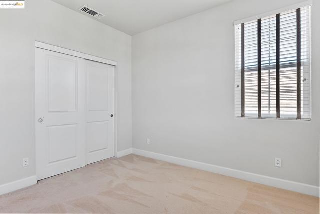 Unfurnished bedroom with carpet and a closet