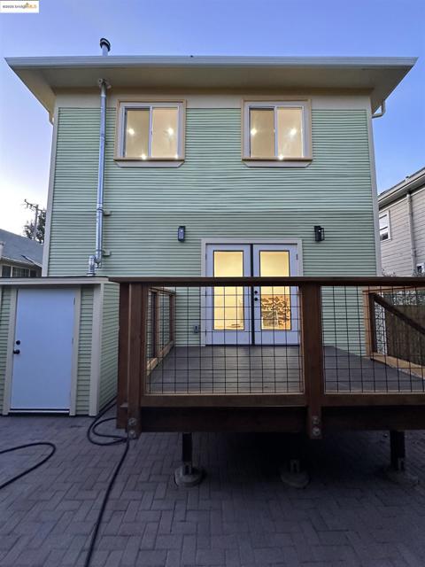Rear view of house with a wooden deck