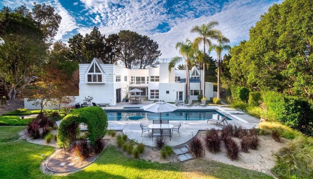 4557 Vista De La Tierra Del Mar, California Incomparable find in Del Mar! On a beautifully maintained and manicured one-acre lot, is this one-of-a-kind 5,439-square foot home. With 6 bedrooms, 6 baths and ample natural light flowing throughout the entire airy and open space is the ultimate family home. The great room, featuring tall ceilings and a unique, huge skylight in the family room, welcomes family gatherings around the fireplace or in the large eat-in kitchen and dining room. Step through the great room to the stunning backyard; flat and very usable, to an alluring lap pool with diving board and attached spa, set into a pool deck with multiple lounging areas. The verdant lawn and mature landscaping surrounding the entire front and backyard, ensures complete privacy, relaxation and opportunity for a myriad of entertainment possibilities. The primary bedroom is located on the first floor, with dedicated access to the backyard, its own fireplace and stunning views to the outside. Up one of the home's two staircases, are the remaining five bedrooms and four baths. Plus, an additional entertainment space with a walk out balcony with views of the massive backyard and glimmering pool. With an all-white interior palette, hardwood and tile floors, recessed lights/chandeliers and endless windows throughout, this home lights up any time of day. Close to beaches, I-5 Freeway, and the Flower Hill shopping center, this home encapsulates the indoor/outdoor California lifestyle. The unique architecture and ultra-private layout of this exquisitely manicured home is a haven for family and friends...Welcome home. Equipment: Garage Door Opener Sewer: Septic Installed Topography: LL