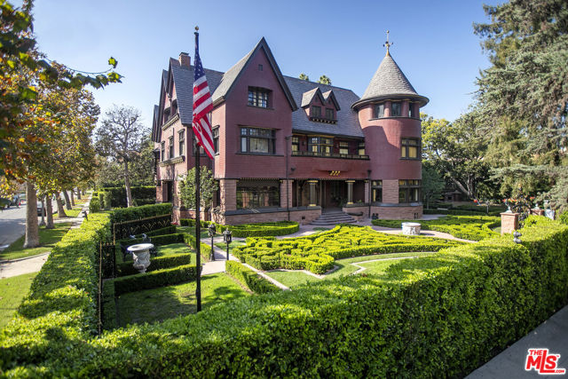 357 Lorraine Los Angeles, California This historic property has recently undergone a meticulous restoration. Entirely modernized with carefully preserved original character. Built in the 1890's by Isaac Newton Van Nuys, this 3-story Victorian was moved to its current location in Windsor Square by his son J. Benton Van Nuys in 1915. The luxurious main residence offers 8 Bedrooms and 7.5 baths. The 2 bedroom 1 bath carriage house is located above the spacious garage. A car turntable is set into the driveway. Ornate iron gates and tall hedges surround and privatize the property, providing an escape from the bustling city. A labyrinthine landscape frames the stunning path to the main entry. The traditional floor plan offers a grand salon that seamlessly flows to the library/den and formal living room/sitting room. The dining room is lined with linen-fold paneling & leaded, stained glass windows and is connected to the chef-quality kitchen, which has been fully renovated in keeping with the home's original style. A chef's garden sits just outside. The hidden bar with hand carved walls has a secret door leading to the show-stopping in-ground pool and spa with both covered and sun drenched seating areas. There are 5 bedrooms on the second floor with multiple suites and sizable custom closets. The upper level provides 3 additional bedrooms, 2 baths, and an especially unique living space that doubles as an automated theater with surround sound, a stage with original footlights, a dramatic turret side room & bar. Newly implemented and/or restored systems throughout include the foundation, multi-zone HVAC, roof, plumbing, electrical, pool/spa, security and backup generator. This estate's grand-scale and handcrafted details lend a magical quality to this timeless piece of art. Rich in history and reconditioned with great care, this is a rare opportunity to own one of the finest estates in Los Angeles.