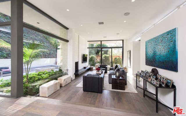 9466 Cherokee Lane Beverly Hills, California Hidden and set back from the street behind gates lies this completely renovated Mid-Century Modern surrounded by lush and mature landscaping. Private and serene, the interior boasts floor-to-ceiling windows allowing for a ton of natural light and bringing the greenery inside. The master suite is located on one side of the home with a private outdoor area, spa-like bathroom with dual sinks, and a very spacious walk-in closet. Formal dining room with beautiful glass bar steps down to the formal living room complete with a white-washed brick fireplace and lovely views of the outdoors. The bright kitchen features stainless steel Wolf appliances, lots of cabinet space, and is connected to the separate family room. Additional highlights include two separate guest bedrooms, wide-plank hardwood floors, skylights, and steel-framed windows and doors throughout. Outside, a large grassy yard in front and great entertaining space with kitchen and fire pit in the back complete this sophisticated property located just minutes from the Beverly Hills Hotel and conveniently located to both Beverly Hills and West Hollywood. Seller MAY credit buyer for a pool upon accepted offer.
