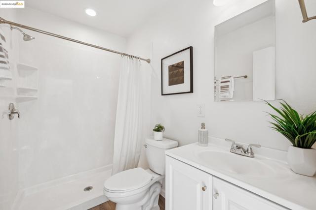 Full bath featuring a stall shower, vanity, and recessed lighting