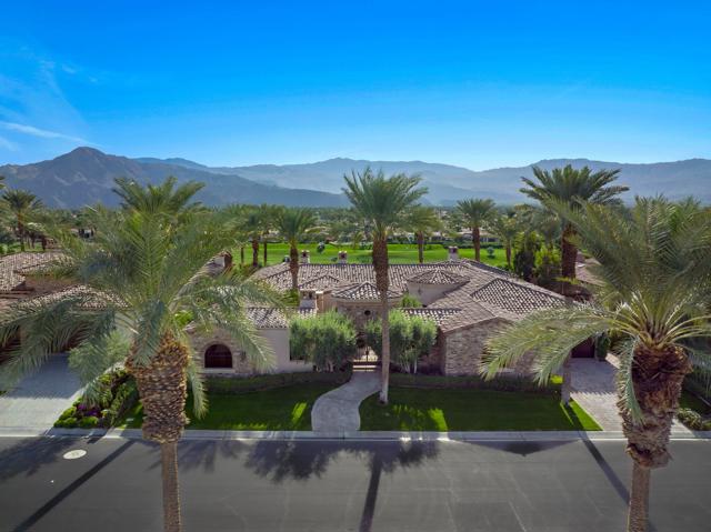 Indian Wells is home to this south facing custom estate located inside gated Toscana Country Club. Romantic features are prevalent in this contemporary custom villa from the moment you enter into the gated courtyard. Your eye will be immediately drawn to the jaw-dropping panoramic mountain views and double fairway while taking with it the large outdoor living/dining areas replete with pool, spa, fire pit and covered outdoor kitchen. The true display of genius lies in the graciously designed floor plan that allows true California desert living to unfold. Walls of glass open up to allow the exterior and interior living and dining spaces to live as one. The gourmet kitchen will be the place where you captivate your family and friends to experience culinary delights and perhaps the sous chef in the butlers kitchen as your back up. Store your wine collection in the temperature controlled wine room. The formal octagonal dining room is exquisite, or enjoy the view from your informal dining area large enough to seat the entire family and guests. The impressive master suite has double baths, double custom walk in closets, double shower, soaking tub & 2 water closets! Three other uncompromising suites for your guests offer the ultimate in luxury, including a quaint and private 2 room detached casita with a fireplace, bath and kitchenette!  A cozy den, separate laundry room, 2 powder rooms and a huge exercise/office area complete this amazing home. It is simply Stunning!
