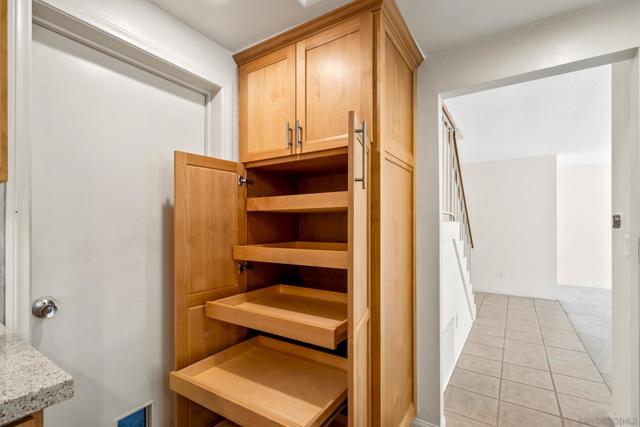 Kitchen features pull-out cabinet shelving