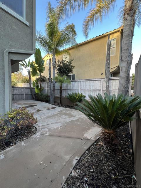 PRIVATE PATIO WITH MATURE LANDSCAPING AND DRIP IRRIGATION.