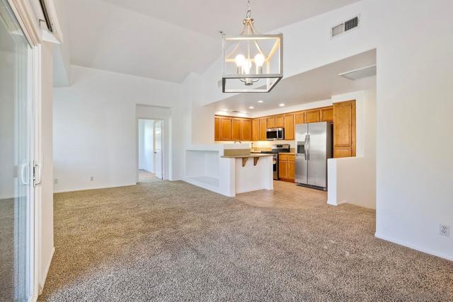 Brand new stylish light fixture in the dining room.  Very open floorplan with vaulted ceilings and great light!