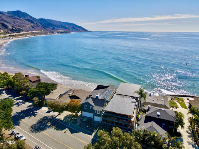 This ocean front new construction home with unbelievable views is a Modern Cape Cod nestled on the water's edge in Faria Beach. On the coastline between Ventura and Montecito, this idyllic spot allows for its residents to surf, kayak, swim, fish, sunbathe, take in the sunset, and stargaze. Enjoy phenomenal views from the family room, dining room, kitchen, wine-tasting room, and primary suite. The many windows, decks and balconies provide incredible vistas of blue waves, marine life, white water, and the surfers' paradise known as Mondo's Beach. The first level includes a three-car garage, great room with incredible views, a wine-tasting room or den with water views, a downstairs bedroom, a downstairs laundry room and two downstairs baths. The chef's kitchen offers an expansive island, custom cabinetry, natural stone counters, gourmet appliances, and a built-in espresso maker, all overlooking the Pacific. Upstairs, the oceanfront primary suite includes a bedroom with a private beachside balcony, multiple windows for enjoying the views and catching the breeze, an ocean view spa-inspired bathroom and a luxury walk-in closet and dressing room. There are three additional bedrooms, two more baths, as well as a media room and upstairs laundry room. Well-placed skylights, transom windows and large glass doors offer natural light, and a curated palette of stone, wood and beautiful tile combine with lighting and plumbing fixtures selected to provide each room with its own special features. Built by Central Coast Engineering, this ocean front home has been thoughtfully designed to include a timeless elegance that will blend cohesively with a variety of interior furnishing selections. Whether for a primary residence or oceanfront escape, this incredible brand-new home will delight your senses as you enjoy the good life on the California coast. This home is not behind the gates, however it is a part of the Faria Homeowners' Association, which includes access into a gated community with a tennis court, park and private access to the famed Pitas Surf Point.
