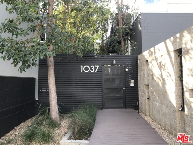 1037 N Laurel Avenue 13 West Hollywood, California Chic, contemporary 3 level townhome is available in the architecturally significant Lofts at Laurel Court. A classic LA courtyard style building reimagined for the modern era. This is a rare opportunity to acquire a remodeled loft with bonus room that opens to a huge, private wraparound rooftop deck with sweeping panoramic views. A GREAT PRIVATE OUTDOOR SPACE. Unit 13 is a top floor unit featuring a large, light-filled living room with walls of glass and 20ft. ceilings adjacent to an open concept kitchen. Finishes include polished concrete, European white oak hardwood flooring, marble counter tops and high end stainless steel appliances. Primary bedroom with huge custom walk-in closet/dressing room. Washer and Dryer in unit. Custom electric, remote control operated shades. Nest HVAC system. Additional storage in Garage. Video available upon request. Also available for sale at $995,000.