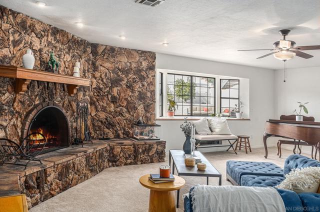 A huge living area, a cozy working fireplace and ample seating, also features a stunning stone accent wall