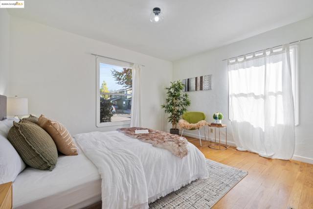 Bedroom featuring wood-type flooring and baseboards
