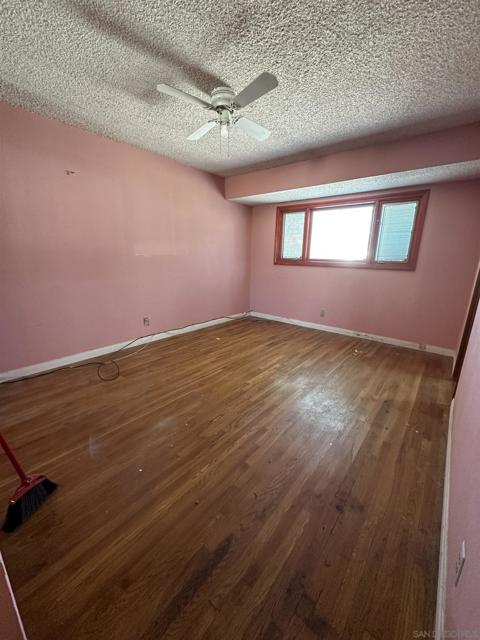 Master bedroom features windows with wood frames, hardwood floors and an oversize closet.
