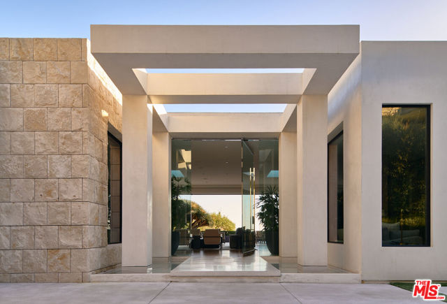 1510 Loma Vista Drive Beverly Hills, California Built to complement the pedigree of the prestigious Trousdale Estates enclave of Beverly Hills by the world-renowned architect, Michael Marquez, this compound of contemporary flow and thoughtful detail is meticulously programmed for a discerning new owner of luxurious taste. Bathed in natural light from floor-to-ceiling walls of glass, the living space is both sophisticated and functional with high-end finishing, five beds, seven baths, smart home technology, and a custom dual-sided fireplace A chef's kitchen masterpiece is complete with Miele appliances, a Blue-star range, 150-bottle wine room with a pouring station, Sub Zero refrigerators and custom cabinetry. A primary wing boasts lavish spa-like bathrooms of travertine including dual vanities, shower, and a sitting tub. Complete with dual walk-in closets and vaulted ceilings, the bedroom flows open to the private backyard. The outdoor oasis is exclusively nestled in the Trousdale hillside against the LA skyline with entertaining spaces among a lushly manicured space, an infinity pool and a spa.