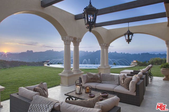 7 Beverly Ridge Terrace Beverly Hills, California This exquisite European Villa located within the prestigious guard-gated enclave of Beverly Ridge Estates is a delicate combination of stunning architectural design and dramatic scale! Situated on approximately two acres of land, gorgeous sunsets serve as the perfect backdrop to the infinity-edge pool, floating sky deck and stunning canyon views. This tranquil setting is surrounded by sprawling lush landscape, mature fruit trees with vistas of green from every room inspiring a seamless transition within your own private oasis including pool, spa, open cabana, outdoor kitchen and BBQ area. The main floor of the estate is designed for entertaining and features a striking grand entry with hand carved wood-paneled ceiling, a Great Room with soaring ceilings, beautiful stone fireplace, reclaimed barn wood beams, open Living Room, Formal Dining Room, Wet bar, Gourmet Kitchen, Wine Room, Gym, Theater and beautifully appointed Family Room. The design features contemporary finishes and luxurious elements such as antique doors imported from Spain, onyx countertops, handcrafted cabinets, imported Moroccan tiles, and reclaimed barn wood flooring from Stoddard, New Hampshire. The Master suite with private office and terrace overlook this idyllic and serene setting. A rare opportunity for privacy, security and a lifestyle that one can only dream of!