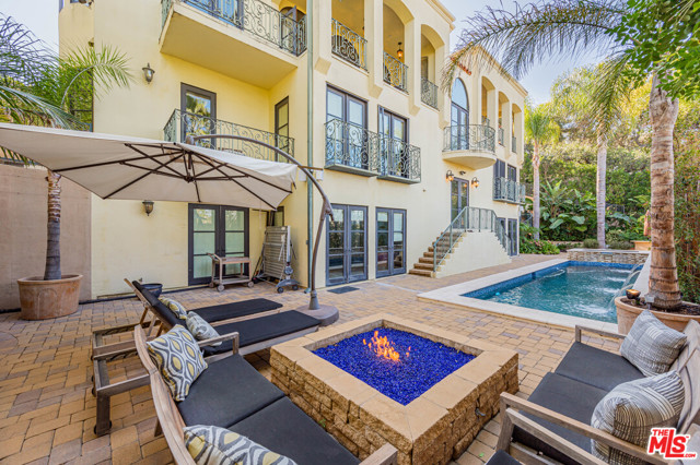 3110 Benedict Canyon Drive Beverly Hills, California Situated on a private street off of Benedict Cyn on a promontory sits this Mediterranean villa. There are spectacular views looking east and west from this very private designer home. Open floor plan with terraces are great for entertaining. Large open Chefs kitchen features top of the line stainless steel appliances, granite counter tops and large walk in pantry. There is an office, family room, gym, media room, and temperature controlled 1,200 bottle wine cellar. The fully remodeled master suite includes hardwood floors, an oversized custom closet, newly redone master bathroom with steam shower and Japanese-style bathtub. There are 3 additional en-suite bedrooms. The private backyard features a non-chlorine ionized swimmers pool, spa, outdoor kitchen, and entertaining area with fire pit. Filtered water system, smart home automation for in-ceiling speaker systems, TVs, thermostats, elevator, cameras and room to add guest house - abundant flat land.
