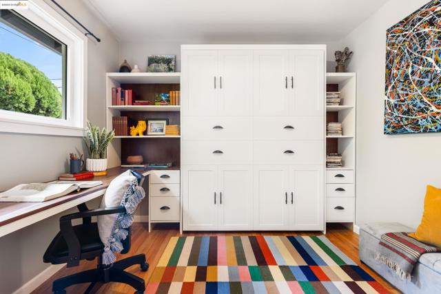 Office space with light wood-type flooring and built in desk