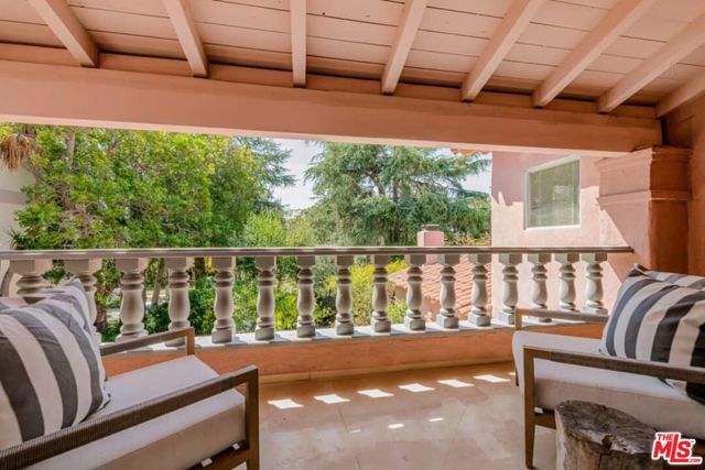 311 21St Place Santa Monica, California A gem of historic Santa Monica, just 1 block below San Vicente, this 3bd/3bth 1937 Spanish Revival with a modern architectural interior is on the market for the first time in 40 years. An expansive light-filled living room with ceramic tile fireplace and custom built library offer warmth and quiet. The galley kitchen flows from the breakfast room to the backyard and connects to a large bonus room. Upstairs, there are two bedrooms and an office. The large primary bedroom with ensuite full bathroom and walk-in closet has french doors that open to a private balcony with gorgeous tree-top views. Front and back patios offer peaceful seclusion. Detached garage in the backyard gives easy access to/from from the alleyway. A great property, ready as is or to remodel or re-configure. Mature fruit trees including lemon, orange, fig, and kumquat surround the ample front and back yards while Japanese maple, pine, and ficus offer privacy. And just a tree-lined stroll to coffee, ice cream, and shopping at the Brentwood Country Mart and Montana Avenue.