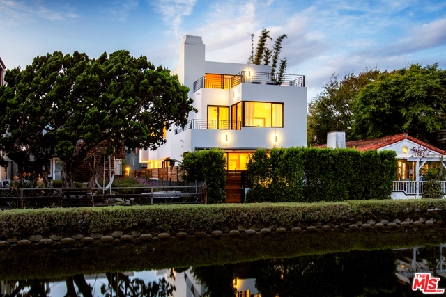429 Sherman Canal Venice, California In a world-renowned neighborhood of awe-inspiring homes, this sophisticated 3-level architectural on the historic Venice Canals captivates and enchants. Designed by the distinguished architect, William R Pauli, AIA, the home boasts 10ft ceilings, walls of glass, and a preferred south-facing exposure. The open floorplan allows an easy flow from the cook's kitchen through the great room out to the inviting front deck and yard; ideal for canal-side al fresco dining. The 2nd level features a spectacular master suite replete with a fireplace, balcony overlooking the canal, walk-in closet, and a luxurious bathroom with oversized shower and stone-clad tub. An office nook and 2 additional bedrooms complete the 2nd level. The 3rd level is an exceptional and flexible space with extraordinary views, 2 fabulous decks, and a full bathroom; prime for a media room, den, or extra bedroom.