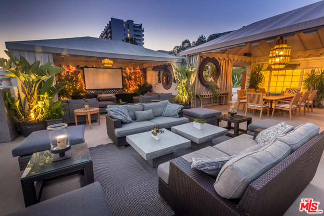 8732 Shoreham Drive West Hollywood, California Hollywood Regency Townhouse. This Historic Landmark has been home to some of the brightest stars of the silver screen. Spectacular Private Roof Top Terrace with Panoramic Views. Enter through a private gated, courtyard with lush gardens, koi pond, and original vintage fountain. Elegant living room with beautiful walnut floors and a fireplace that has a gorgeous marble mantle. Formal dining room with an exquisite French chandelier. Chef's kitchen. Seductive and Chic yet welcoming and comfortable. Upstairs are two lovely bedrooms with en-suite bathrooms that have picturesque views of the gardens and courtyard from every window. Guest room, office or creative space with bathroom and a private entrance is downstairs. The third floor is a spacious 2000 sq.ft. roof top terrace with spectacular views from the Westside to Downtown. Tented dining area with an outdoor kitchen. This beautiful retreat is situated just above the bustle of Sunset plaza, yet it is completely quiet and private.
