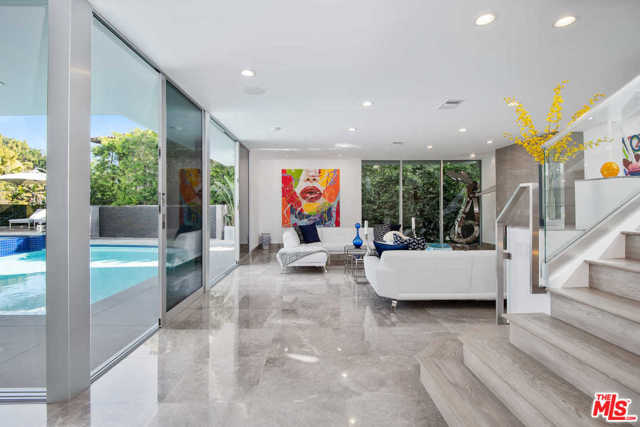 1250 ANGELO Drive Beverly Hills, California This newly reimagined contemporary tour de force soars above the city lights in the prestigious Beverly Hills and Holmby Hills area. Capturing breathtaking vistas this masterpiece showcases voluminous living spaces and unprecedented finishes. Designed for entertaining, an open floor plan is highlighted by towering ceilings and sliding walls of glass and resort-caliber pool, spa and entertainer's terraces with cascading waterfalls throughout the house. A sprawling great room with a fireplace that opens up to a built-in fully equipped bar with top tier temperature-controlled wine storage. This flows to a gorgeous dining room and sophisticated chef's kitchen with Miele appliances and Poggenpohl cabinets. The stunning master suite is replete with a private terrace with views, showroom closets, and exquisite dual bathrooms, three over-sized VIP guest suites, a state of the art media room with views and a gym with a dry sauna complete this extraordinary high tech smart house retreat.
