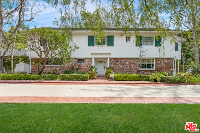1061 N Woodland Drive Beverly Hills, California A magnificent Beverly Hills estate situated on over 1.1 entirely FLAT acres, a street to street lot (with a separate entrance on 1072 N. Beverly Drive). A gracious traditional Beverly Hills home with large living room, paneled library/office, bar, formal dining and breakfast room. 4 bedrooms + maid's, large owner's bedroom suite with fireplace and dual baths. French doors and windows open to incredible park-like grounds with enormous lawn, swimming pool, spa, and championship-size tennis court. This classic Beverly Hills estate has incredible potential to remodel, add, and create the ultimate dream estate.