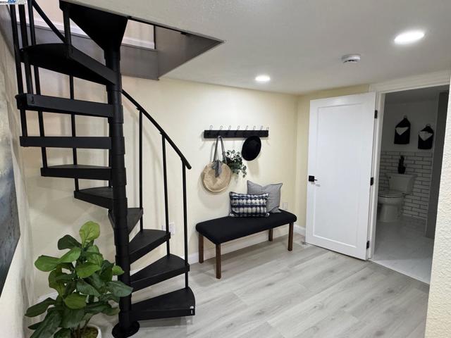 Spiral staircase descends to the lower 2 bedroom expansion area.