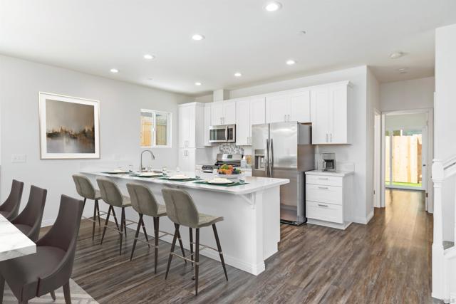 Virtually Staged - Kitchen with seating and eating area.