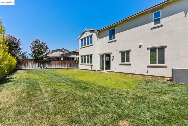 Back of house featuring stucco siding