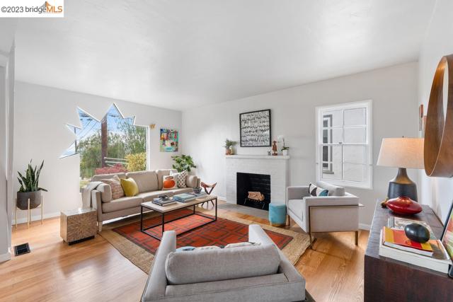 Large living room features the original wood burning fireplace.