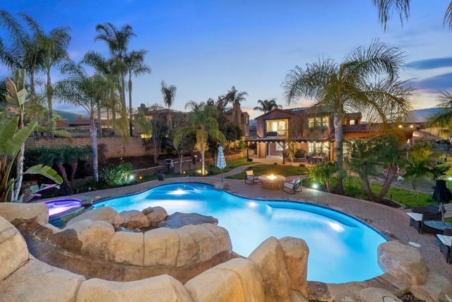 View of home from top of slide stairs leading to pool.