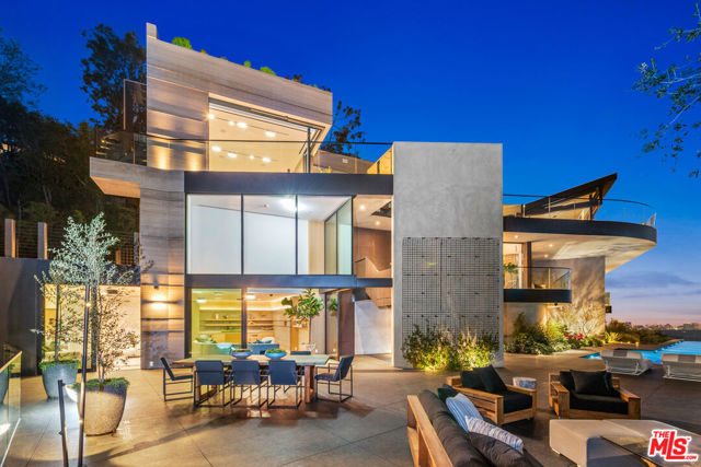 Brought to you by Group S Architects with interior and exterior designed by Tagfront, this new contemporary estate was constructed using the finest materials featuring breathtaking views of the city and ocean from nearly every room in the house. Designed to exemplify the beauty of organic elements, this architectural triumph is perched high up on the hillside in the coveted Beverly Hills area. Custom marble is book matched to seamlessly transition from piece-to-piece with natural wood features incorporated throughout, the timeless design is a perfect blend of modern architecture and natural warmth. With multiple wrap-around terraces, a spacious rooftop patio, and an infinity edge pool and spa, the home boasts incredible outdoor space, ideal for dining al fresco and entertaining. Adjacent to the expansive living room and bar, the chef's kitchen with professional grade appliances is designed and manufactured by Boffi. The master bedroom is situated conveniently on the southwest corner of the home to provide the perfect ambiance showcasing the view with an opulent closet and bathroom. Along with the Crestron smart home system and automatic floor-to-ceiling doors, this home is equipped with all the modern amenities anyone would ask for. Unbelievable sunsets can be enjoyed from any vantage point of this one-of-a-kind Beverly Hills masterpiece. This is an incredible architectural and design triumph that is truly the epitome of luxury and style.