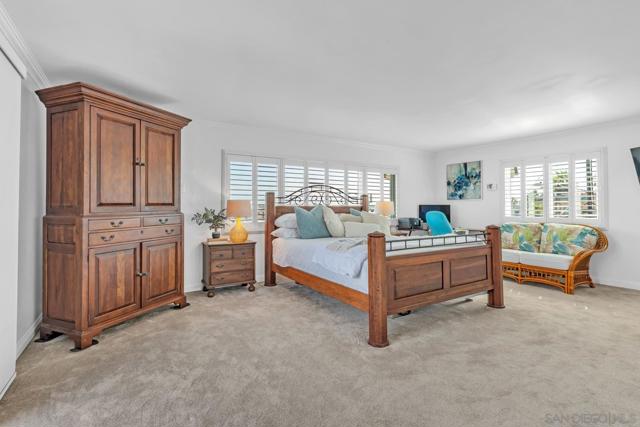 Oversized primary bedroom with Bay views and direct access to rear deck.