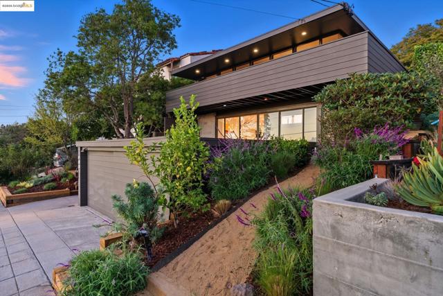 Property exterior at dusk featuring a garage and driveway