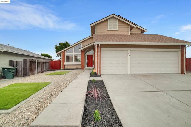 View of front facade featuring brick siding, a shingled roof, and driveway