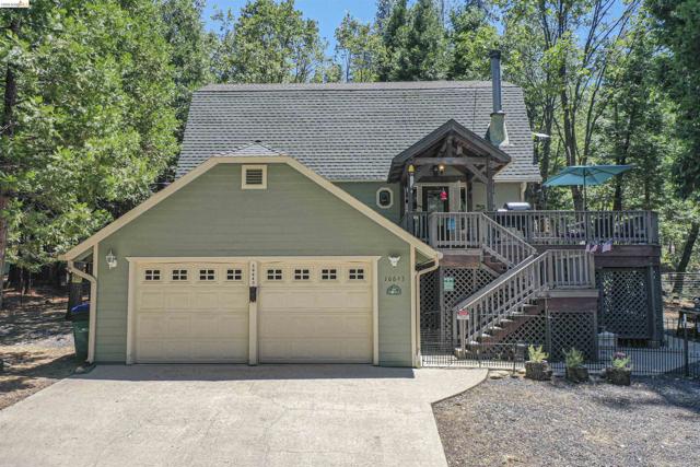 Multi-level exterior with a two-car garage, expansive elevated deck with wooden railings, and a covered entry porch