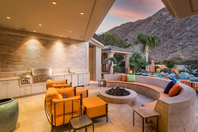 This unique and outstanding residence was created by renowned designer, Guy Dreier. It is a one-of-a-kind piece of property! The gated entry courtyard with pool, spa, and fireside seating leads to the interior floor plan of the home. Offering 9,854 square feet on the upper level and around 4,000 square feet on the lower level - including the air conditioned garage. The upper level of the home includes an expansive main suite with a seating area, a sleeping area, 2 walk-in closets, a massive shared bath and a gentleman's office. The guest accommodations offer 2 spacious en suite rooms with a shared sitting area. The great room provides spectacular fairway views and a center-peak skylight. The living area has a sit-down bar, access to the formal dining area, and to the gourmet-style kitchen with relaxed seating. A stunning staircase, and an elevator located in the kitchen area, provide easy access to the lower level entertainment enclave. Reflecting the bygone days of the Fabulous 50's, the authentically designed diner leads to The Ritz movie theater where you can watch your favorite Hollywood flick in style. Be sure to get a soda and some popcorn at the diner or make a quick stop at the ticket booth/candy counter for your favorite movie snack.The grotto-style wine cellar (hidden behind a wine barrel keg door) offers intimate dining for 10 and promises to provide an elegant experience enhanced by fine wines and champagnes.