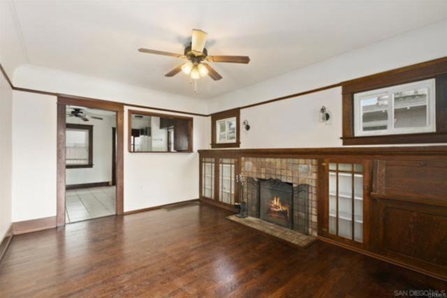 Photo taken prior to current owner moving in. Living Room was kept as-is with orig hw flooring