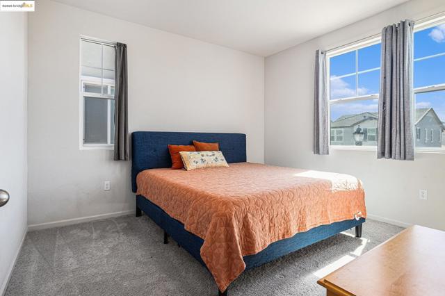 Bedroom featuring carpet and baseboards